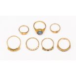 Seven assorted 9ct gold rings, including a synthetic sapphire channel set ring,