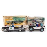 Tinplate: A boxed tinplate battery operated Police Jeep, together with a boxed Police Convertible,