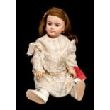 Mon Cheri: A bisque head Mon Cheri doll, jointed knees and elbows, open eyes, fingers intact, 26"
