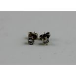 A pair of diamond stud earrings, each four claw set round brilliant cut diamond, post and