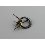 A silver and yellow metal "swallow" brooch, fashioned as a silver ring with offset centre and