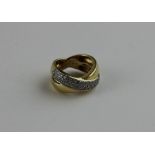 An 18ct. yellow gold and diamond ring, fashioned as one gold band crossing over another, the outer