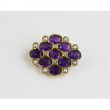 A 9ct. gold, amethyst and seed pearl brooch, of lattice pattern and lozenge shaped, set nine oval