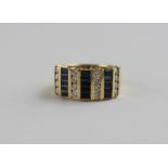 An 18ct. yellow gold, sapphire and diamond ring, having alternating vertical rows of four channel