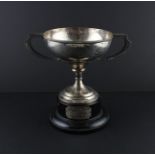 A silver twin handled circular trophy cup, assayed Chester 1911, makers mark rubbed, having twin