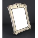 An Arts & Crafts silver mirror, by Elkington & Co Ltd, assayed Birmingham 1908, having shaped and