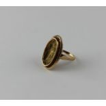 An 18ct. yellow gold dress ring, of ovoid form, having dished matt finish central face relief cast