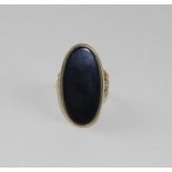 A 9ct. gold and black onyx dress ring, set large oval cabochon black onyx, hallmarked London
