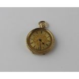 An 18ct. gold ladies' pocket watch, crown wind, having gold Roman numeral chapter ring with engine