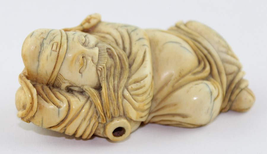 A late 19th century Chinese ivory Lohan, the recognisable figure in recumbent pose, 6.5 cm long - Image 4 of 5