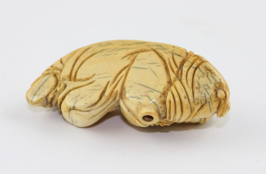 A late 19th century Chinese ivory Lohan, the recognisable figure in recumbent pose, 6.5 cm long - Image 3 of 5
