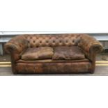 An early 20th century leather chesterfield, two seats