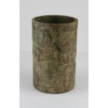 A carved jadeite cylinder, possibly Maori, having relief carved frieze of fertility figures with