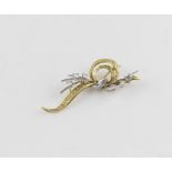 An 18ct. yellow and white gold and diamond floral brooch, having textured yellow gold fashioned as a