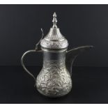 An Islamic dallah silver coffee pot, 20th century, of traditional form, repousse flowers and