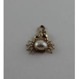 A 14ct. yellow gold "crab" pendent, set mabe pearl as its carapace, impressed "585" and "14K". (