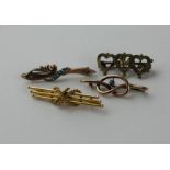 A 15ct. yellow gold bar brooch, fashioned as three off-set gold rods with bead terminals tied by a