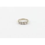 An 18ct. white gold and five stone diamond ring, set row of five round old brilliant cut