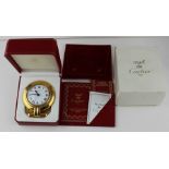 A Cartier Colisee travel alarm clock, c.1992, having signed white enamel Roman numeral dial with