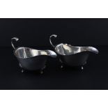 A pair of silver sauce boats, by Bishton's Ltd, assayed Birmingham 1962-3, having flying scroll
