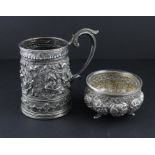 An Indian or Burmese white metal tankard, of circular reverse tapered form, having embossed,