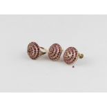 A pair of 18ct. yellow gold and pink garnet earrings, of large conical form, set round cut pink