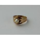 A yellow metal and pearl ring, four claw set pearl to centre, (yellow metal assessed as 18ct. gold).