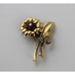 A large yellow gold, diamond and ruby floral spray brooch, fashioned as an open flower to stem
