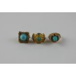 Three Middle Eastern style yellow metal and turquoise rings, to include; a yellow metal and