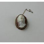 A 9ct. gold mounted oval shell cameo brooch, carved in high relief with a bust portrait of a lady,