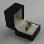 A 14ct. yellow gold, diamond and blue topaz asymmetric dress ring, of angular design, set round