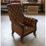 A Regency buttoned leather library chair with gilt floral decoration