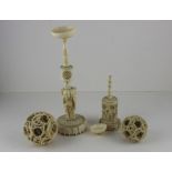 A Chinese Qing dynasty ivory puzzle ball on stand and smaller example