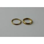 Two 22ct. yellow gold bands, hallmarked Birmingham 1926 and Birmingham 1940 respectively. (total