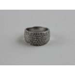 An 18ct. white gold and diamond dress ring, pave set numerous diamonds, (total diamond weight