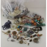 A large collection of costume jewellery, to include semi-precious stone necklaces, brooches and