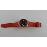 A Tommy Hilfiger stainless steel and orange rubber gentleman's wrist watch, having signed textured