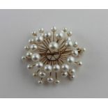 A 14ct. gold and cultured pearl pendant/brooch, fashioned as radiating gold branches terminating