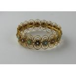 A 21ct. yellow gold and champleve enamel circular bracelet, fashioned as a series of champleve