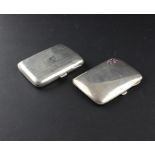 Two silver cigarette cases, both of traditional gently curved rectangular form, the first  by John