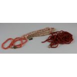 Four assorted coral bead necklaces, to include; a four string blood orange coral bead coral