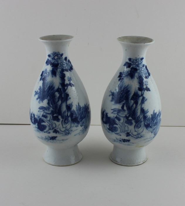 A pair of early 20th century Chinese porcelain vases, decorated with rabbits among foliage to side