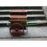 An early 20th cent Hurdy-gurdy with orignal wheeled stand