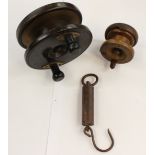 A large mahogany and brass fishing reel,