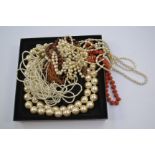 A 1970s style necklace and earring set, a large faux pearl necklace,