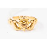 An 18ct gold Claddagh ring, set with a small diamond, 18ct Irish gold, size M,