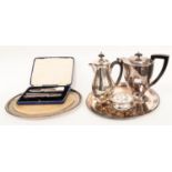 A collection of plated items, including two salvers, a tea pot, ebonised handle,
