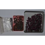 Quantity of rough and polished garnet beads
