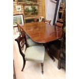 A large twin pedestal mahogany rectangular dining table together with 10 chairs including 2 carvers.