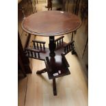 A Victorian ebonised revolving reading table.